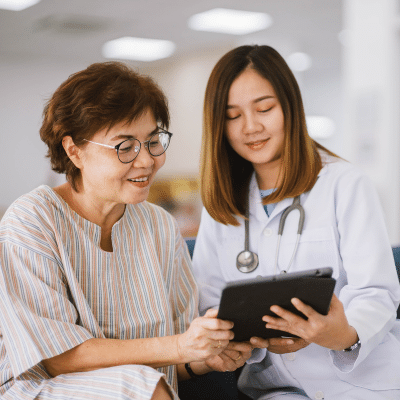 A patient and a doctor looking at a tablet, representing patient-centered practice