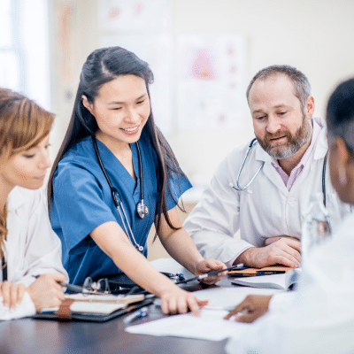 Medical professionals collaborating on documents, representing how to measure success in a medical private practice