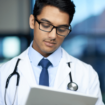 Doctor looking at a clipboard, representing obgyn billing changes