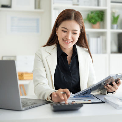 Female doctor working at desk with laptop computer, representing best medical billing company